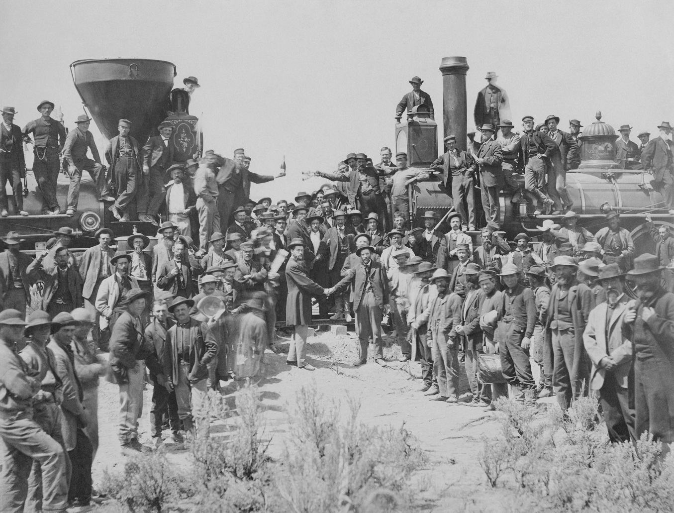 The ceremony for the driving of the golden spike at Promontory Summit, Utah on May 10, 1869; completion of the First Transcontinental Railroad